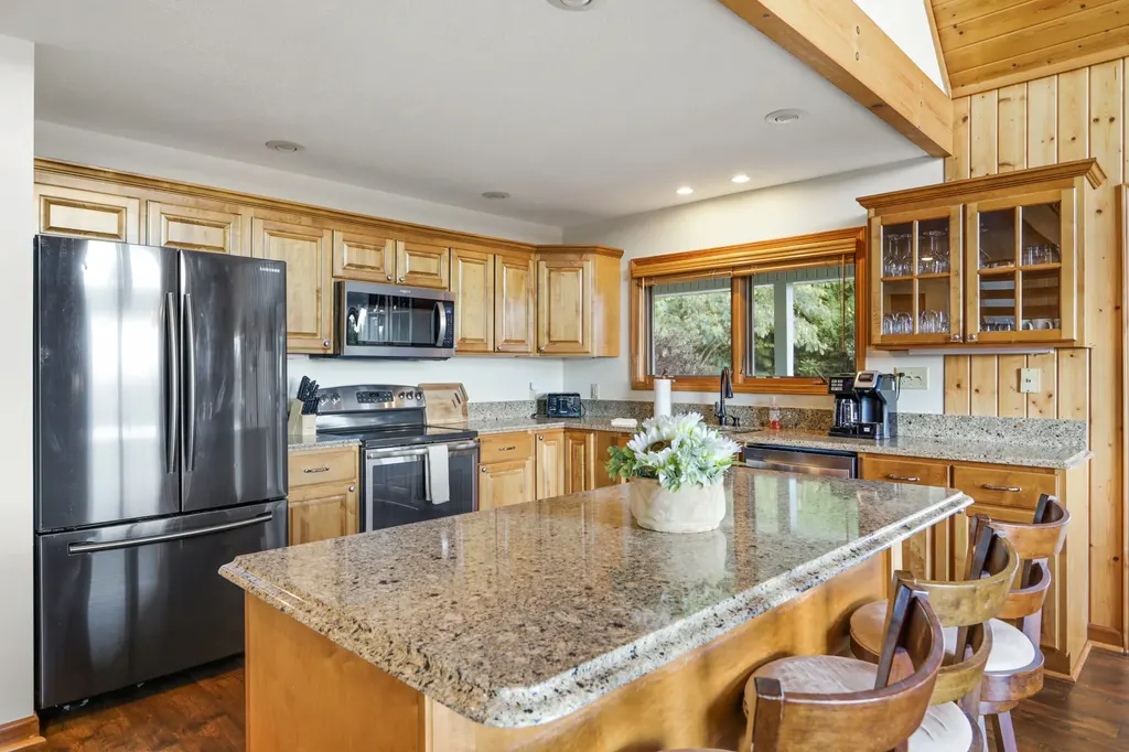 Kitchen island and stainless refrigerator