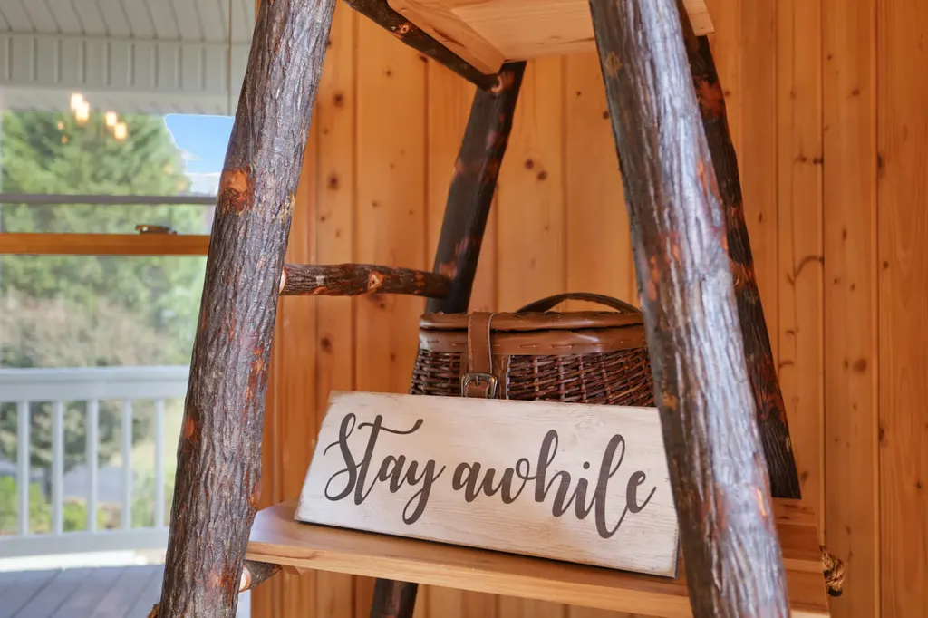 Rustic ladder with Stay Awhile sign
