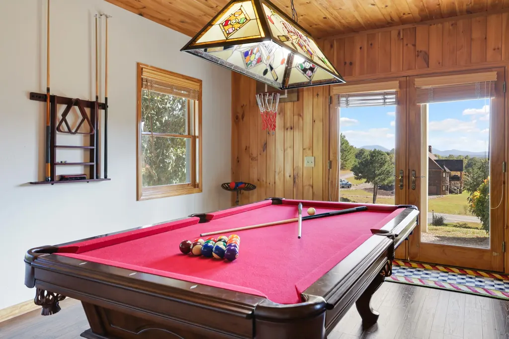 Lower-level game room with the pool table and deck doors