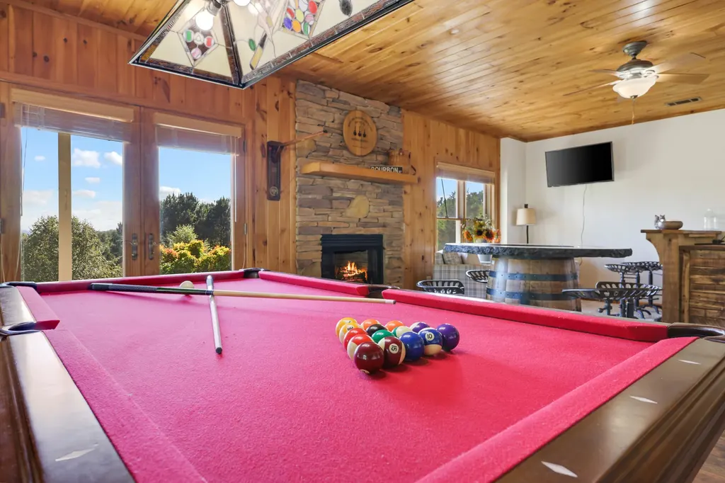 Pool table room with large windows